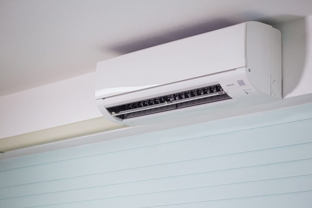 Close-up of a wall-mounted air conditioner indoors, showcasing sleek design for modern cooling solutions.