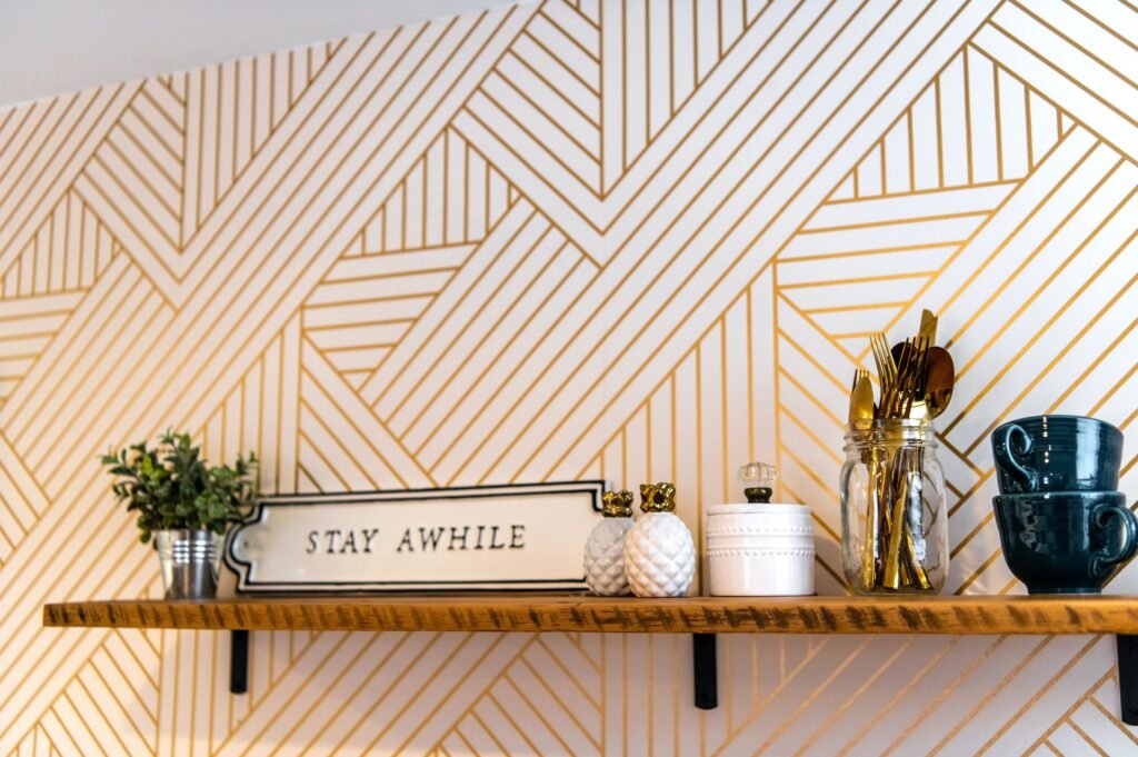 Elegant shelf with cups, decor, and a stylish geometric wall design. Perfect for modern interior inspiration.